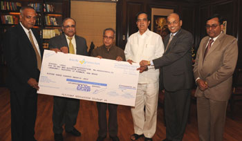 Mr S Raman, Chairman & Managing Director of Canara Bank,  handing over the cheque to Mr Pranab Mukherjee, Union Minister for Finance on September 29 in New Delhi. Also seen in the picture are (L to R) Mr H S U Kamath, Executive Director, Canara Bank, Mr Namo Narain Meena,  Minister of State for Finance, Mr Jagdish Pai K L, Executive Director, Canara Bank and Mr K K Mishra, General Manager, Canara Bank.