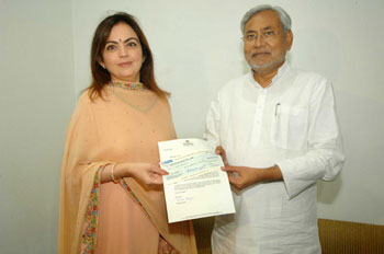 Nita Ambani, Chairpersons of the Dhirubhai Ambani Foundation, handing over a Rs 11 crore cheque to Bihar Chief Minister Nitish Kumar