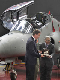 British Prime Minister David Cameron receiving a memento from Hindustan Aeronautics Limited chairman Ashok Nayak during his visit to the HAL centre in Bangalore on Wednesday. A HAWK MK-132 aircraft is seen in the background.